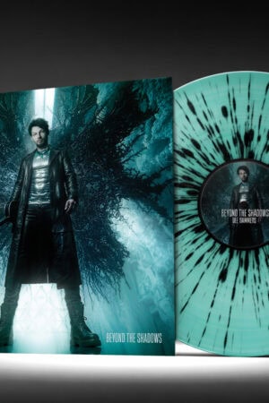 Dee Dammers' "Beyond the Shadows" vinyl album featuring a striking blue and black splatter pattern, showcased alongside the record cover.